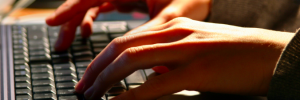 Hands typing on a keyboard